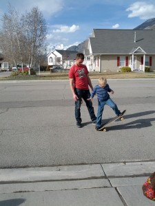 Uncle Brady teaching Benji how to skateboard.