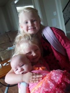 These girls LOVE their little sister.